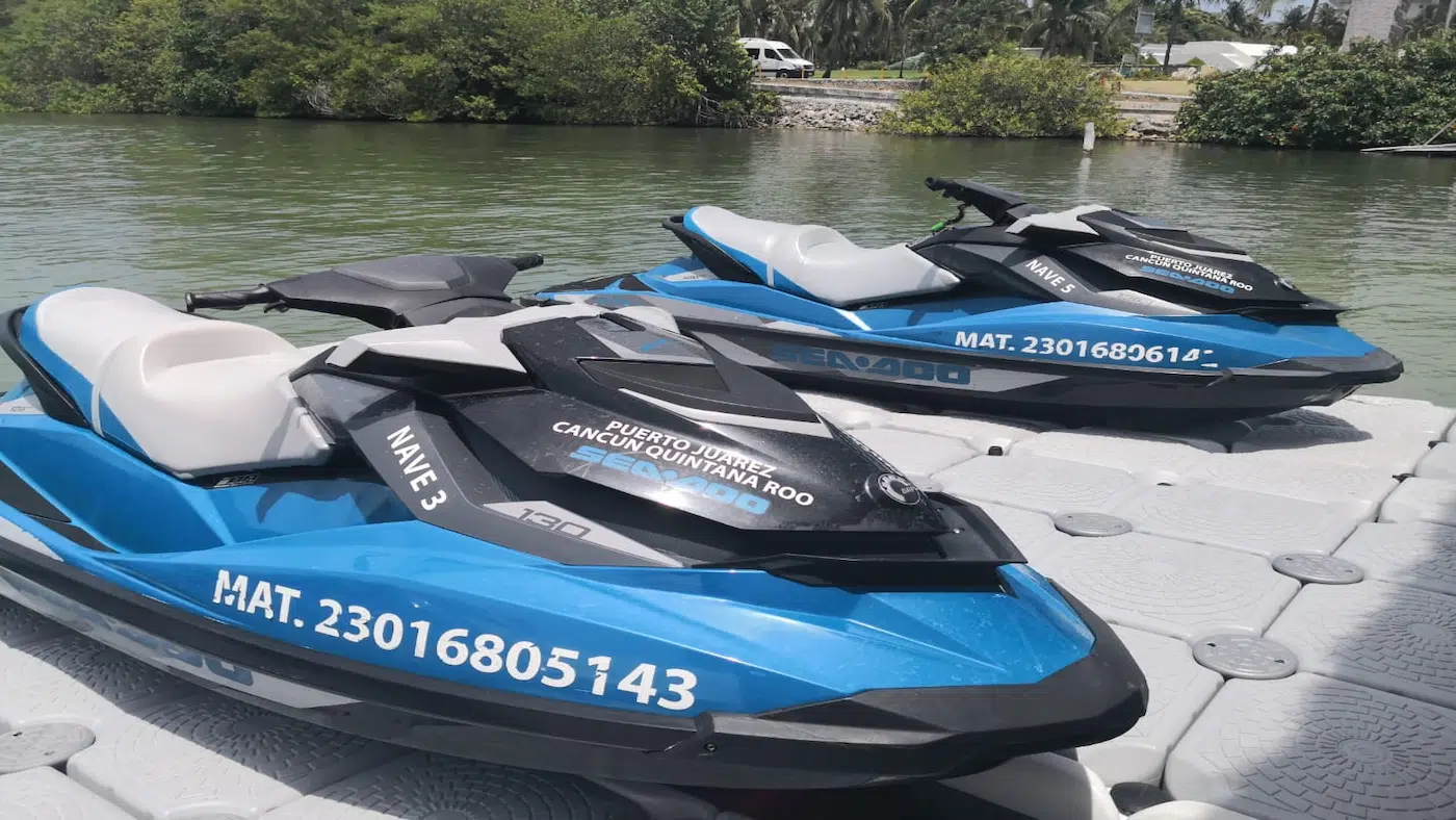 Two Jet Ski Cancun watercraft on a floating plastic ramp