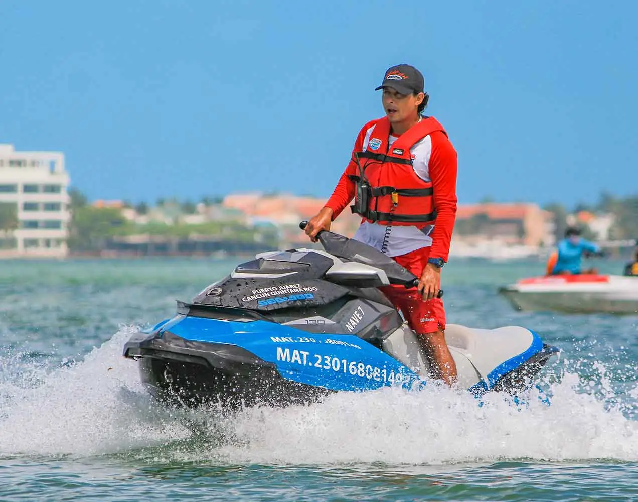 A qualified and experienced crew member is driving your jet ski in the Cancun lagoon