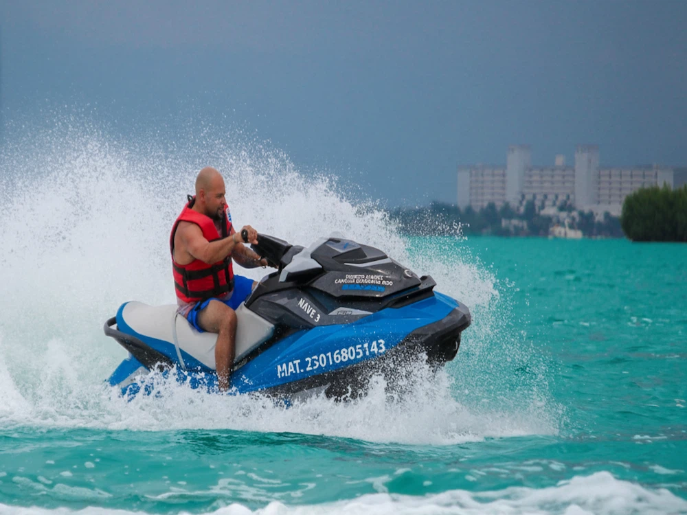 A beautiful young woman drives a jet ski in the sea, rented from Jet Ski Cancun